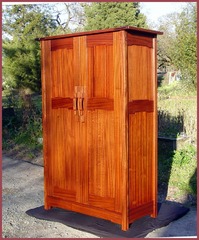 Shown, in dappled shade, with doors closed.  The splotches or dark areas are only partial shade as the sun was setting.  The following image shows the cabinet without the dappled shade, though the bottom area is in shade. The close-ups that follow were also taken in full sun.